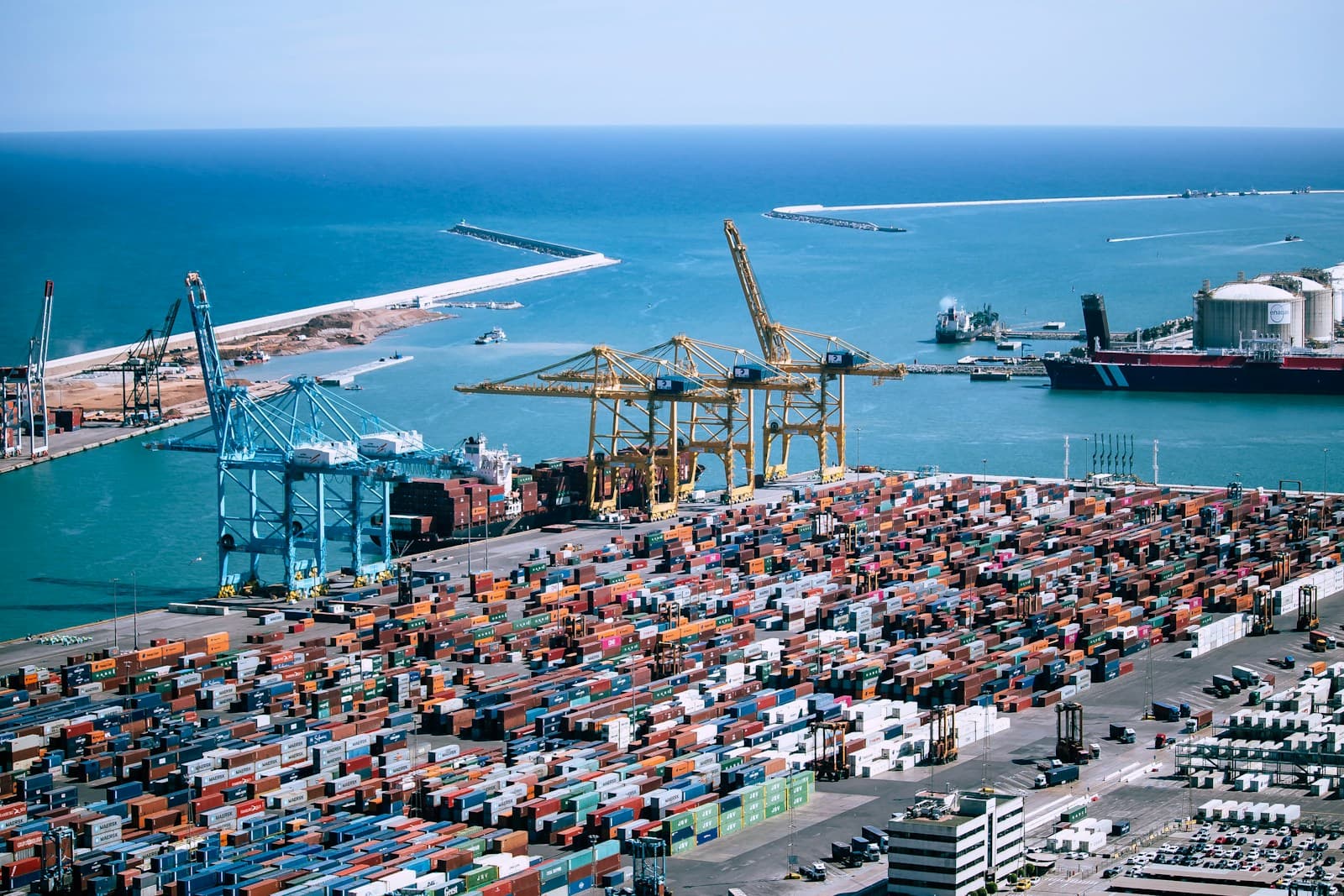 Cargo containers and cranes at the port of Barcelona.