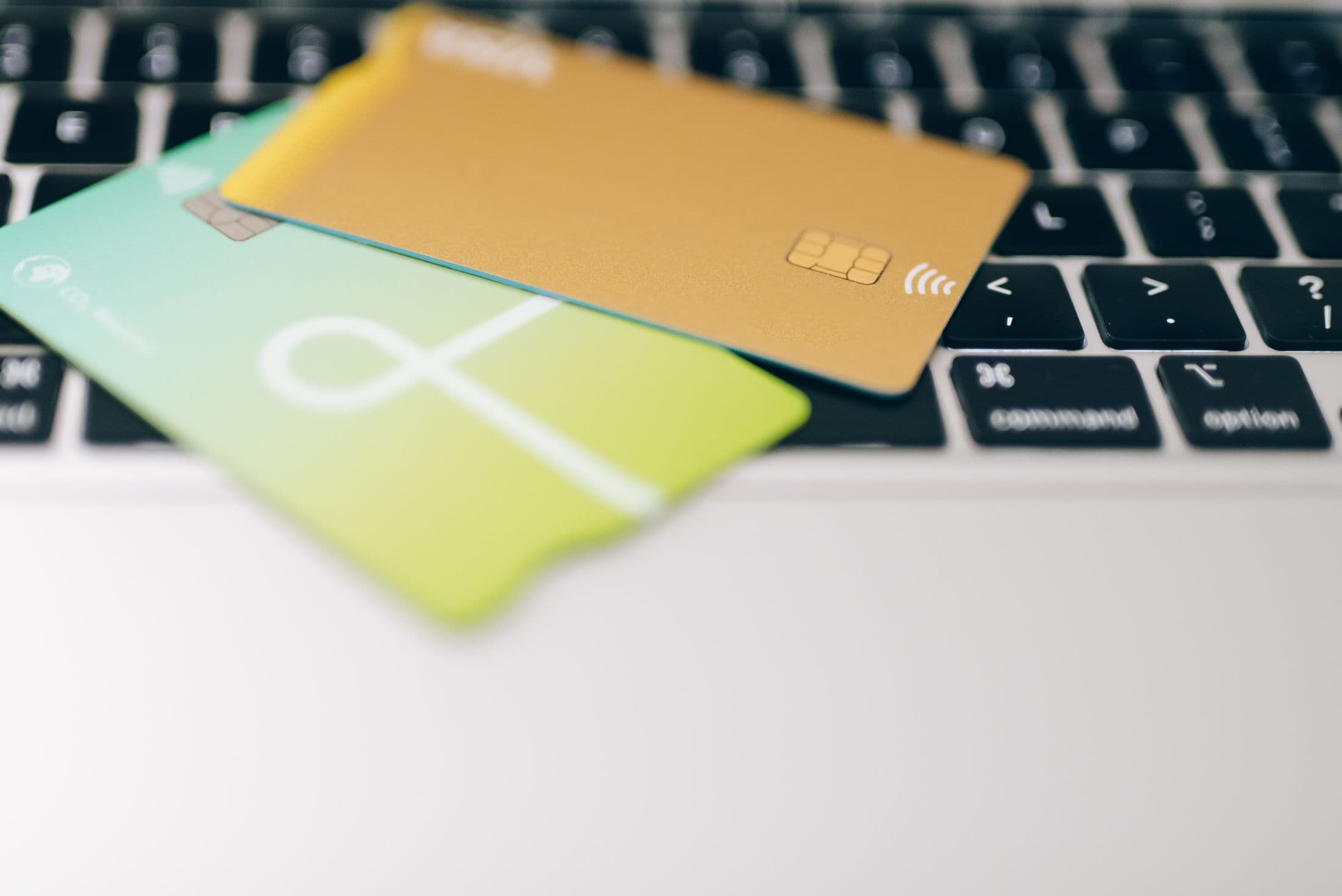 Close-up of payment cards resting on a laptop keyboard.
