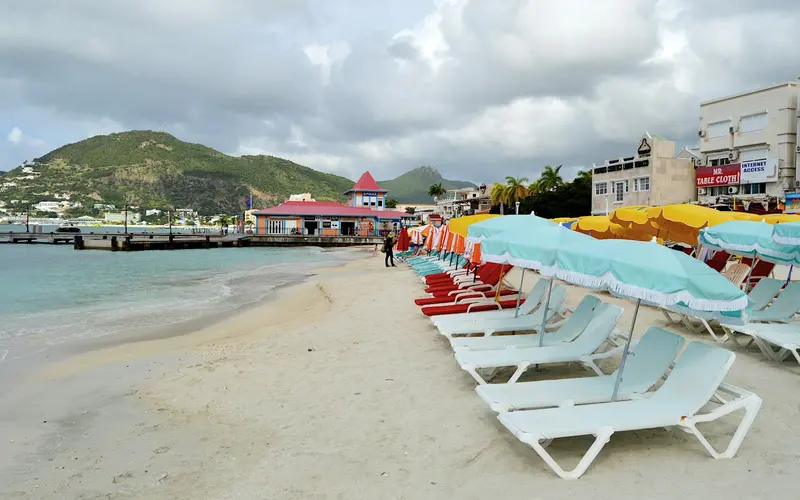 Beach chairs, waterfront buildings and a pier at Great Bay in Philipsburg, Sint Maarten.