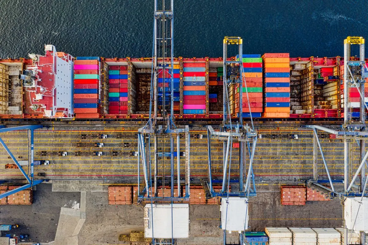 Overhead view of a container ship and quay cranes at a port in Jakarta, Indonesia