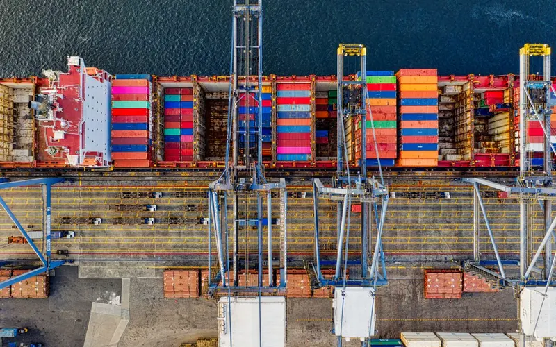 Overhead view of a container ship and quay cranes at a port in Jakarta, Indonesia