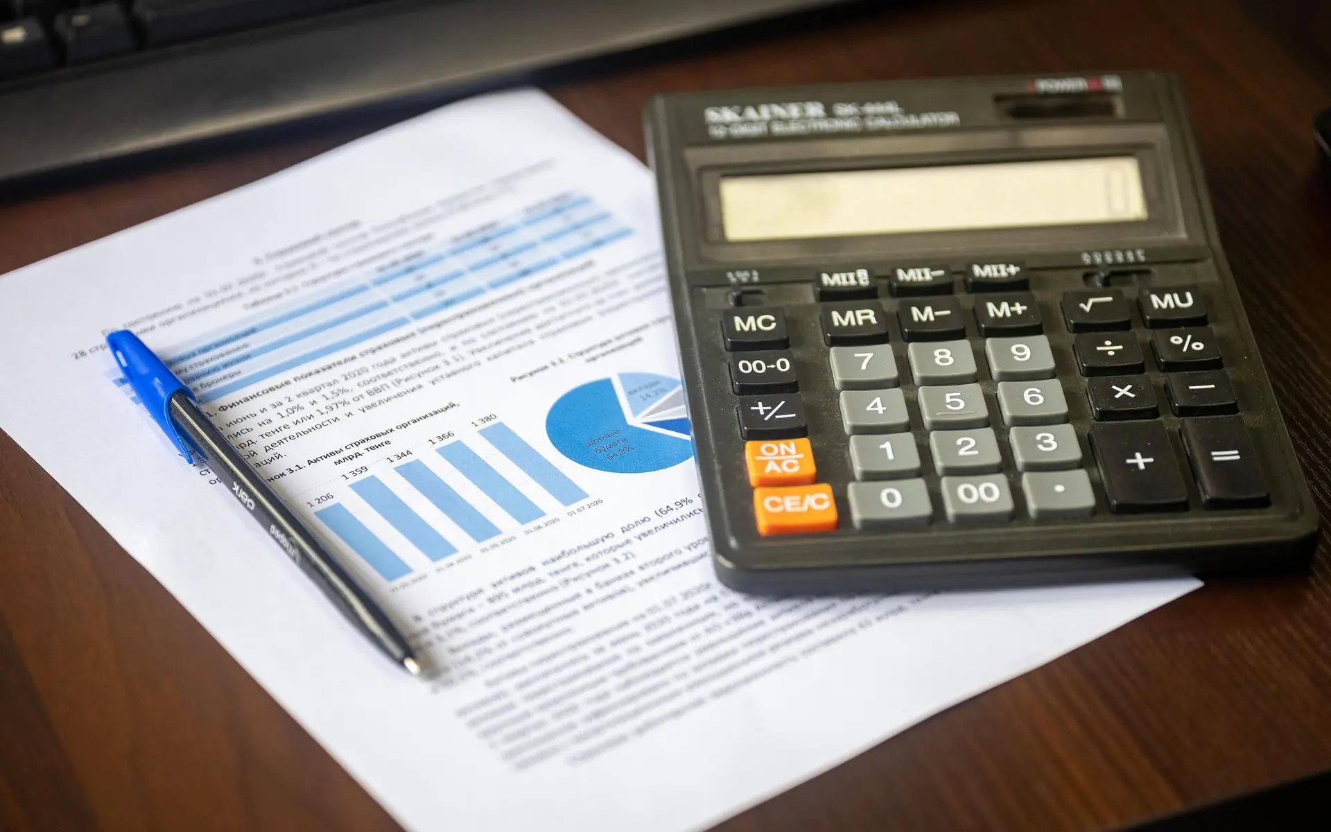 Calculator and pen on a financial report.