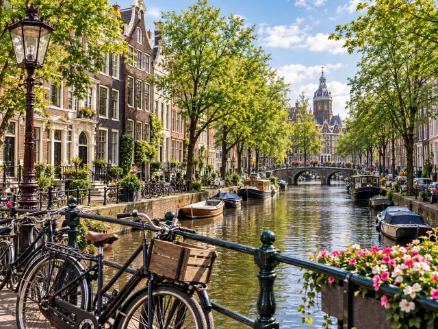 Amsterdam canal with historic houses, bicycles, boats and flowers in the Netherlands